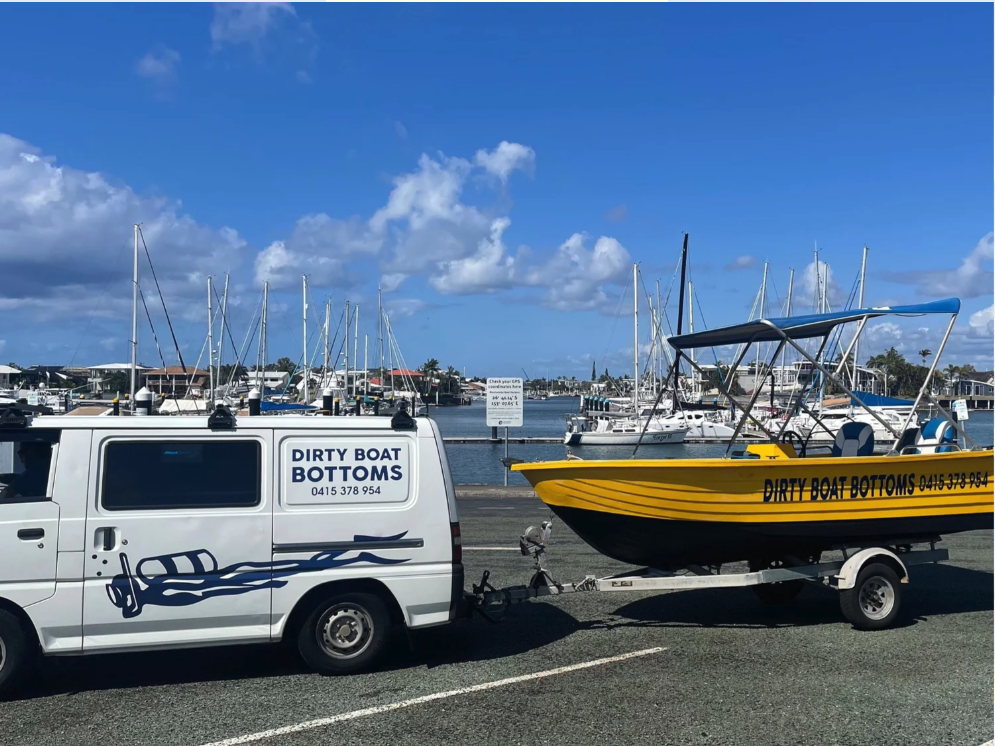 Dirty Boat Bottoms van and work boat at the marina